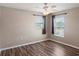 This bedroom features wood floors, a ceiling fan and two windows at 512 Bella Rosa Cir, Sanford, FL 32771