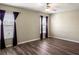 This bedroom features wood floors, a ceiling fan and two windows at 512 Bella Rosa Cir, Sanford, FL 32771