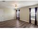 Bedroom with two windows, ceiling fan, and wood-look flooring at 512 Bella Rosa Cir, Sanford, FL 32771