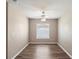 This bedroom features wood floors, a ceiling fan and a large window at 512 Bella Rosa Cir, Sanford, FL 32771