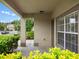 Covered front porch with a view of the manicured landscaping at 512 Bella Rosa Cir, Sanford, FL 32771