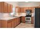 Well-equipped kitchen with wood cabinetry, stainless steel appliances, and ample counter space at 512 Bella Rosa Cir, Sanford, FL 32771