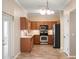 Functional kitchen featuring wood cabinets, stainless steel appliances, and a practical layout at 512 Bella Rosa Cir, Sanford, FL 32771