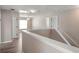 Upstairs landing with a view of a bedroom and a hallway with wood floors at 512 Bella Rosa Cir, Sanford, FL 32771