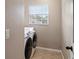 This laundry room includes tile floors, a window, and a washer and dryer at 512 Bella Rosa Cir, Sanford, FL 32771