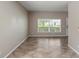 Spacious living room with tiled floors and neutral paint, showcasing a clean, modern space at 512 Bella Rosa Cir, Sanford, FL 32771