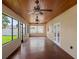 This is a screened-in patio with a wood ceiling and several ceiling fans at 512 Bella Rosa Cir, Sanford, FL 32771