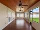 Enclosed patio featuring a wood plank ceiling, ceiling fans, and ample natural light from the many windows at 512 Bella Rosa Cir, Sanford, FL 32771