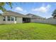 Great backyard with a well-maintained lawn, fence, and covered patio with seating at 5314 Golden Apple Dr, Winter Garden, FL 34787