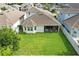 Expansive backyard featuring lush green grass, a screened-in porch, and a well-maintained fence at 5314 Golden Apple Dr, Winter Garden, FL 34787