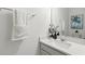 This bathroom features a modern vanity with quartz countertops and a decorative mirror, enhancing its appeal at 5314 Golden Apple Dr, Winter Garden, FL 34787
