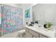 Bathroom featuring a shower with patterned curtain and a vanity with modern countertops and decorative accessories at 5314 Golden Apple Dr, Winter Garden, FL 34787