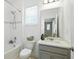 This bathroom features a shower/tub combo, a modern vanity, and abundant natural light at 5314 Golden Apple Dr, Winter Garden, FL 34787