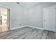 An empty room with hard surface floors, baseboards, and a view to the kitchen provides versatility at 5314 Golden Apple Dr, Winter Garden, FL 34787