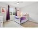 Charming bedroom with purple accents, natural light, and a cozy, inviting atmosphere at 5314 Golden Apple Dr, Winter Garden, FL 34787