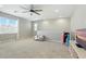 This spacious bonus room features neutral tones and ample natural light, creating a versatile living space at 5314 Golden Apple Dr, Winter Garden, FL 34787