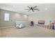 Spacious bonus room features a ceiling fan, plush carpet, natural light, and flexible space for various activities at 5314 Golden Apple Dr, Winter Garden, FL 34787
