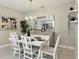Formal dining room with seating for six, a modern light fixture, and neutral paint colors at 5314 Golden Apple Dr, Winter Garden, FL 34787
