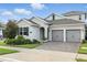 Charming single-Gathering home featuring a two-car garage, brick driveway, and beautifully landscaped front yard at 5314 Golden Apple Dr, Winter Garden, FL 34787