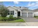 Charming home with manicured landscaping, a paved driveway, and a two-car garage at 5314 Golden Apple Dr, Winter Garden, FL 34787