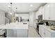 Bright kitchen featuring a large center island, stainless steel appliances, and white cabinetry at 5314 Golden Apple Dr, Winter Garden, FL 34787