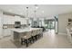 Open-concept kitchen featuring a large island with seating, stainless steel appliances, and backyard views at 5314 Golden Apple Dr, Winter Garden, FL 34787