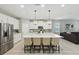 Bright, modern kitchen with stainless steel appliances, a large center island with chairs, and plenty of counter space at 5314 Golden Apple Dr, Winter Garden, FL 34787