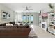 Cozy living room with a ceiling fan, tile floors, large windows, and access to the screened-in backyard at 5314 Golden Apple Dr, Winter Garden, FL 34787