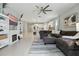 Spacious living room with a fireplace, built-in shelves, tile flooring, and a comfortable seating area at 5314 Golden Apple Dr, Winter Garden, FL 34787