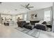 Open-concept living area featuring a large sectional sofa, ceiling fan, and kitchen view at 5314 Golden Apple Dr, Winter Garden, FL 34787