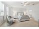 Elegant main bedroom with neutral decor, comfortable seating, ceiling fan and lots of natural light at 5314 Golden Apple Dr, Winter Garden, FL 34787