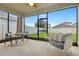 Bright sunroom with a cozy seating area and views of the backyard at 5314 Golden Apple Dr, Winter Garden, FL 34787