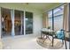 Inviting sunroom has a table for two, perfect for enjoying meals or relaxing at 5314 Golden Apple Dr, Winter Garden, FL 34787