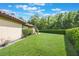 Well-maintained backyard features a level lawn and manicured perimeter hedges at 5413 Via Veneto Ct, Sanford, FL 32771