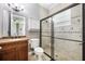 Bathroom showcases a tiled shower, a dark vanity, and a bright ambiance at 5413 Via Veneto Ct, Sanford, FL 32771