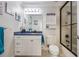Cozy bathroom features a blue granite vanity, a white toilet, and a modern shower with a black frame at 5413 Via Veneto Ct, Sanford, FL 32771