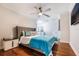 Cozy bedroom with hardwood floors, neutral tones, and a comfortable queen-sized bed at 5413 Via Veneto Ct, Sanford, FL 32771