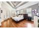 Spacious bedroom with a trey ceiling, hardwood floors, and access to a private balcony at 5413 Via Veneto Ct, Sanford, FL 32771