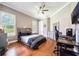 Bedroom with hardwood floors, a ceiling fan, and a large window at 5413 Via Veneto Ct, Sanford, FL 32771