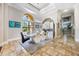 Bright dining room with large windows, modern lighting, and travertine tile flooring at 5413 Via Veneto Ct, Sanford, FL 32771