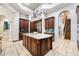 Kitchen view showcasing a large center island, granite counters, stainless steel appliances and custom wood cabinets at 5413 Via Veneto Ct, Sanford, FL 32771