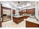 Gourmet kitchen with granite countertops, custom cabinetry, stainless steel appliances, and a center island at 5413 Via Veneto Ct, Sanford, FL 32771