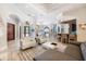 Open-concept living room with tile floors, bar, and plenty of natural light at 5413 Via Veneto Ct, Sanford, FL 32771