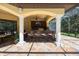 Elegant outdoor kitchen with a granite bar, tile backsplash, and barstool seating at 5413 Via Veneto Ct, Sanford, FL 32771