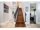 Interior staircase with hardwood steps, a wrought iron banister, and natural light at 5413 Via Veneto Ct, Sanford, FL 32771
