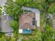An overhead view of a single-Gathering home, featuring a private pool, solar panels, and a long driveway at 5489 Glen Oak Place, Sanford, FL 32771