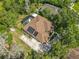 Aerial view of the house featuring a screened-in pool, fenced in yard, solar panels and mature landscaping at 5489 Glen Oak Place, Sanford, FL 32771