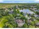 Picturesque aerial view of a community with a serene lake and mature tree coverage at 5489 Glen Oak Place, Sanford, FL 32771