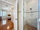Tiled shower in primary bath with glass doors is spacious and well-lit at 5489 Glen Oak Place, Sanford, FL 32771