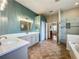 Primary bath with double sinks, tiled floor, and a glass-enclosed shower and soaking tub at 5489 Glen Oak Place, Sanford, FL 32771